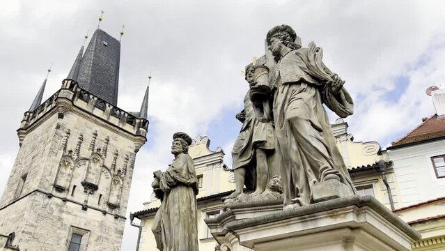 Sculptures adorn city building's facade against the sky.