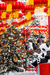 Plush stuffed pandas and Chinese red Christmas lanterns on Tverskaya Street in Moscow. Close-up....