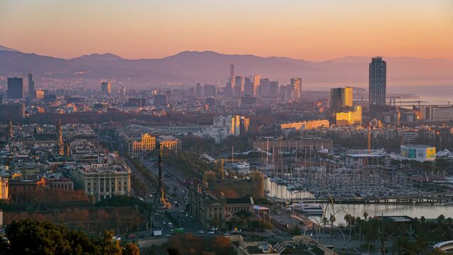 Aerial view time lapse of Barcelona center city sunrise from Montjuic mountain in winter.