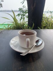 Cup of tea on a terrace overlooking the water
