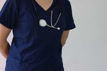 Professional with surgical scrubs with a stethoscope in the shoulders and copy space in the right