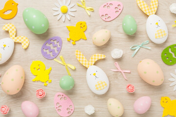 Fototapeta na wymiar Easter eggs and decoration on wooden background, top view
