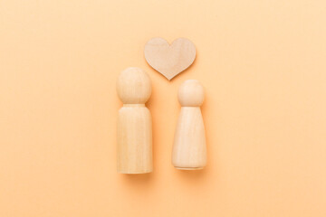 Wooden couple in love on color background, top view. Creative valentine's day composition