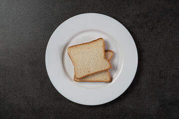 Wholewheat sliced bread in a white plate on a background