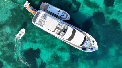 Aerial drone top down photo with copy space of luxury yacht anchored in tropical exotic island with...