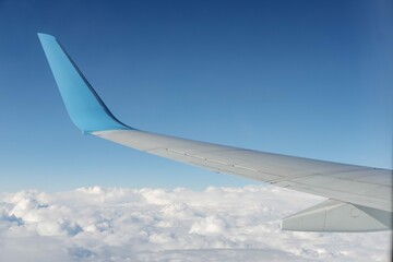 Obraz premium Aircraft Wing View From Airplane Window Seat Blue Sky Cloud