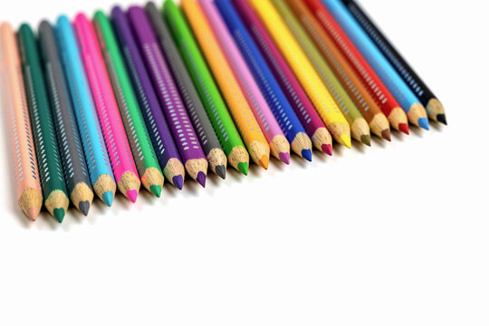 Colored pencils for drawing various colors and coloring book for children.
