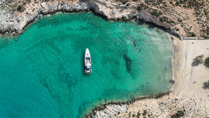 Aerial drone photo from tropical exotic paradise secluded rocky island bay with deep turquoise and...