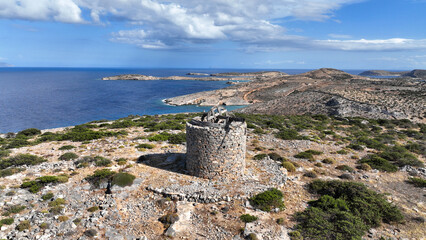 Fototapeta na wymiar Aerial drone photo of old windmill built uphill in island of Schoinousa, small Cyclades, Greece