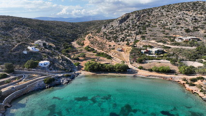 Aerial drone photo of small port of Schoinousa island a safe harbour to yachts and sail boats featuring small beach of Myrsini covered in Almirikia trees, Small Cyclades, Greece