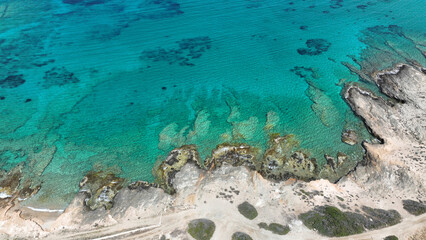 Fototapeta premium Aerial drone photo from tropical exotic paradise secluded rocky island bay with deep turquoise and sapphire sea forming a blue lagoon visited by yachts and sail boats in Caribbean exotic destination