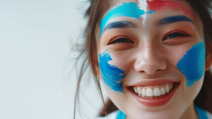 Mongolia flag face paint, Close-up of a person's face, symbolizing patriotism or sports fandom.