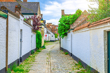 Ludovic Beguinage House Begijnenhuis Ludovicus with white brick walls and narrow street in Beguine city Old St Elizabeth in Ghent city historical center, Gent old town, Belgium