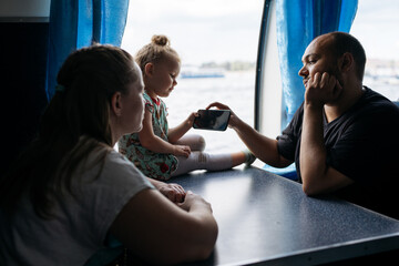 Family Engaging with Smartphone on Leisurely Boat Tour