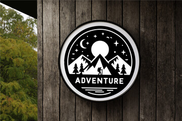Black Mountain Adventure Badge in Circle White Signboard on the empty Wood Wall