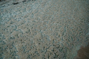 Close up background of piles of foam caused by an algal bloom in the Rio Tapajos, Brazil. Water...