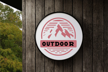 Red Mountain with Outdoor Word in Circle White Signboard. on the empty Wood Wall