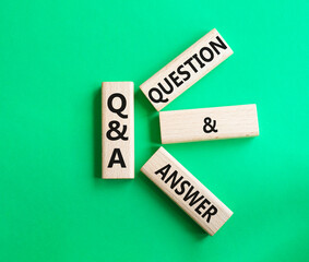 Q and A - Question and Answer. Wooden cubes with words Q and A. Beautiful green background. Business and Q and A concept. Copy space.