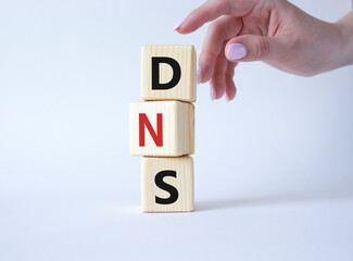 DNS -Domain Name Server - Consumer Price Index symbol. Concept word DNS on wooden cubes....