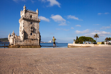 Young man doing exercise near Belém Tower
