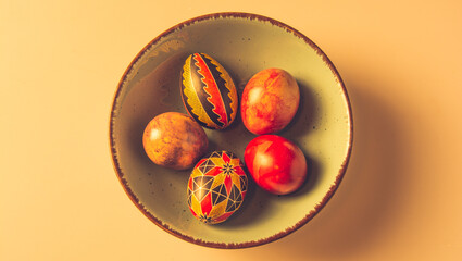 Easter eggs in a bowl on a light background with copy space