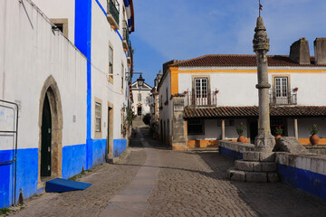 narrow street in the old village of Obidos in Portugal - 732022761