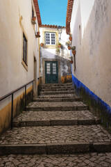 narrow street in the old village of Obidos in Portugal - 732022778