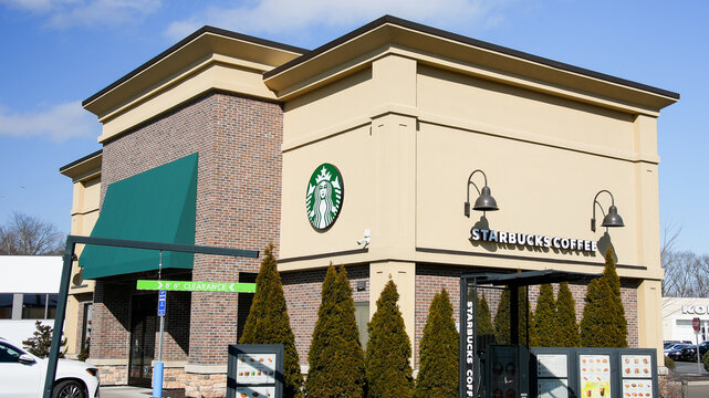 NORWALK, CT, USA - FEBRUARY 9, 2024:   Starbucks coffee building near Post road in Norwalk in nice sunny winter day