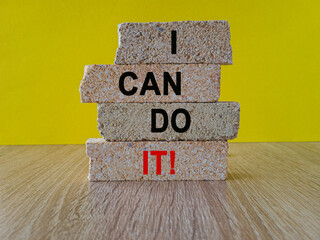 Concept words I can do it on brick blocks. Beautiful yellow background, wooden table. Business and I can do it concept.