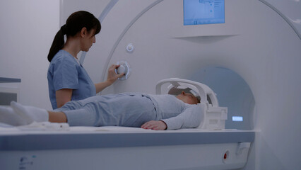 Female doctor, radiologist does cancer prevention examination for female patient in advanced...