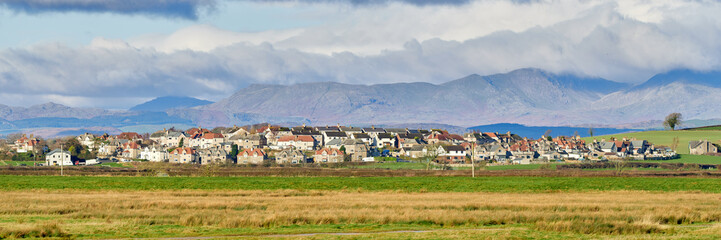 Panorama of Ravenstown, on the Cartmel Peninsula with the lake district fells in the distance.