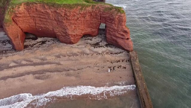 red langstone rock next to the sea and on the beach at dawlish warren