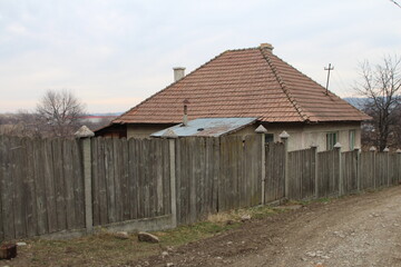 Fototapeta na wymiar A wooden fence and a house