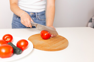 person cutting tomato