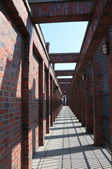 Long portico with red bricks, Germany - 732043177