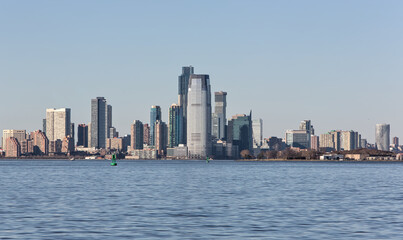 Fototapeta na wymiar downtown jersey city nj view (tall buildings on the waterfront with hudson river in the foreground) new jersey