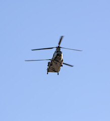 military helicopters flying in blue sky (chinook style chopper with double blades) two copters (presidential transport over hudson river in new york city)