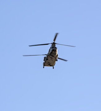 military helicopters flying in blue sky (chinook style chopper with double blades) two copters (presidential transport over hudson river in new york city)