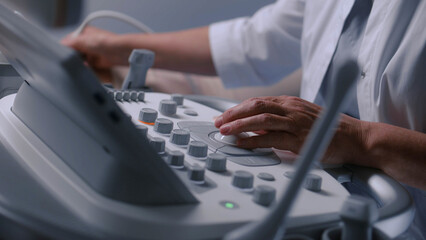 Close up of doctor using ultrasound machine. Professional medic does abdominal organs sonography...