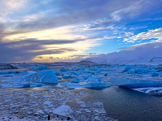 Icebergs swimming at the famous glacier lagoon around Vatnajokull National Park during winter...