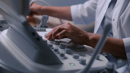 Close up of doctor using ultrasound machine. Professional medic does abdominal organs sonography...