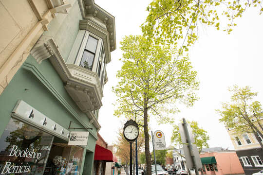 Benicia, California, USA - April 32, 2023: Afternoon foggy sunlight shines on historic downtown Benicia buildings.