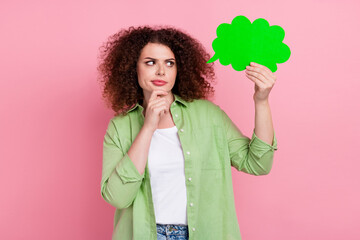 Photo portrait of attractive young woman hold look skeptical comics cloud dressed stylish green clothes isolated on pink color background