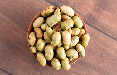 A Bowl of Dry Roasted Edamame Soybeans on a Wooden Table