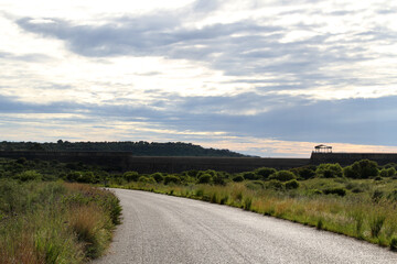 Muddy  dirt road in the Willem Pretorius Nature Resort. Alllemanskraaldam wall in the Sandrivier river, Free State, South Africa. 