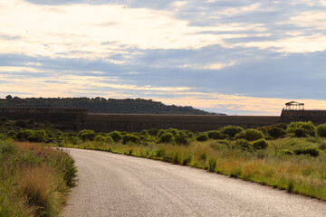 Muddy  dirt road in the Willem Pretorius Nature Resort. Alllemanskraaldam wall in the Sandrivier river, Free State, South Africa. 