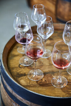 Wine glasses over wine barrel.