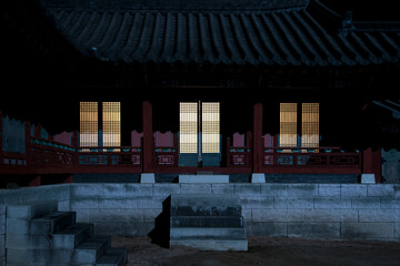 Naklejka premium the exterior of an illuminated traditional Korean building at night