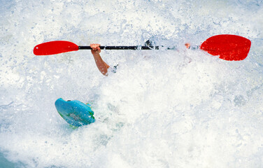 Kayaker almost going under in a wave of the Isar at the Wittelsbacherbrücke, Munich, Germany
