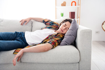 Photo of tired overworked guy dressed checkered shirt sleeping sofa closed eyes indoors house home...
